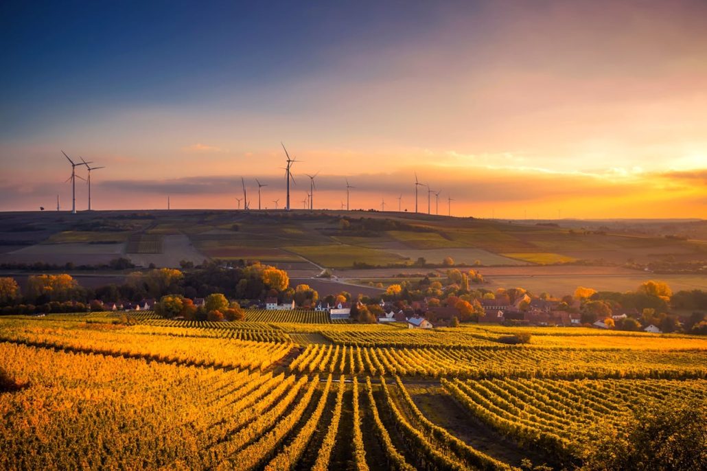 pexels-photo-325944 Breathtaking view of a countryside landscape with wind turbines and vivid sunset.